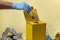 Yellow disposal box for contaminated or infectious products in a hospital or home