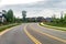 Yellow dividing strips on the road in city, Blue sky, cloudy