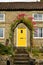 Yellow door, house pink roses