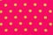 Yellow dot over pink polka dot fabric background and texture.