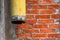 Yellow drainpipe and red brick wall