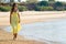 Yellow dress stroll on beach