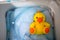 Yellow duck doll taking a bath for clean concept in the washing