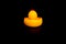 Yellow duck is located back. abstraction black background thinking the reasoning thought of the concept