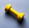 Yellow dumbbell Isolated on blue background