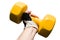 Yellow dumbbell in a male hand isolated