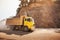 The yellow dump truck driving on a dusty mountain road