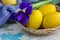 Yellow Easter eggs in basket and blue iris