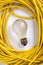 Yellow electric cable and light bulb
