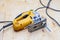 A yellow electric jigsaw ready for work use on the workbench with sawn plywood in a workshop for carpentry work. Tool for industry
