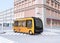 Yellow electric powered  autonomous shuttle bus driving through a intersection