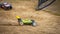 Yellow electric RC buggy racing on an offroad outdoor track