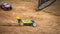 Yellow electric RC buggy racing on an offroad track