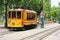 A yellow electric trolley on Main Street in downtown Memphis, Tennessee in summer