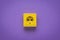 Yellow electrical outlet on a purple background