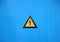 Yellow Electrical Warning Triangle Sign on Blue Background