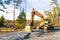 Yellow excavator building a road