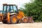 Yellow excavator, bulldozer machine and worker tractor. Road works. Road machinery at construction site.