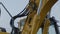 Yellow excavator on construction site close up heavy hydraulic equipment