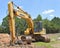 A yellow excavator with demolition claw