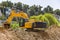 Yellow excavator machine with risen boom construction site