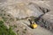 Yellow excavator stonecutter in a quarry for granite