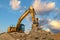 Yellow excavator at stunning fluffy clouds