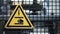 Yellow factory safety sign on grid at industrial plant machine background