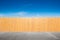 Yellow fence and bue sky background