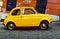 Yellow Fiat 500 parked in Rome.