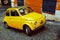 Yellow Fiat 500 parked in Rome.