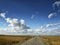 Yellow fields under a dramatic blue sky with white clouds nearby the ancient greek colony of Histria, on the shores of Black Sea.