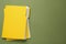 Yellow files with documents on olive background, top view. Space for text