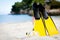 Yellow fins and snorkelling mask on beach in summer