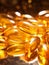 yellow fish oil capsules, omega 3, on background