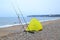 Yellow fishing tent on a pebble beach