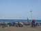 Yellow flag. Beach. Yellow flag to be careful on the shore of the beach of the Mediterranean Sea. Beach full of bathers and touris