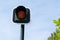 Yellow flashing orange traffic light signal for cars blue sky background