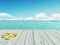 Yellow flip flops on a wooden floor by the seashore