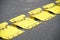 Yellow flow traffic control plates for one way direction of cars