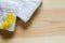 Yellow flowers on white towels with soft shadow on vintage wooden background