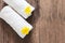 Yellow flowers on white towels with soft shadow on vintage wooden background, top view