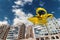 Yellow flying taxi against the sky, city electric transport drone. Car with propellers, clean air, fast ride. Mixed media, copy