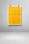 Yellow folded poster hanging on a clean wall with clips