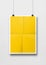 Yellow folded poster hanging on a white wall with clips