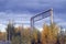 Among the yellow foliage of the trees and the clouds in the sky in the fall of the bridge is visible