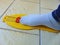 Yellow foot measurement device with foot upon