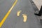 Yellow foot symbol for walk path on road