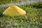 Yellow Football trick lies on the lawn closeup illuminated by sun