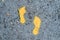 Yellow footprint signs on the floor for pedestrian. Symbol of walkway